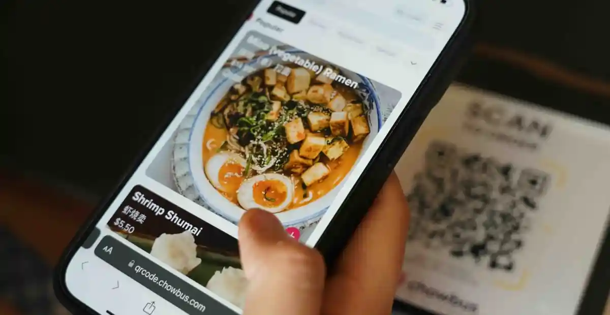 How a QR Code Ordering System Reduces Staff Workload in Hotels 1 Customer using mobile QR ordering system to browse food menu in hotel restaurant