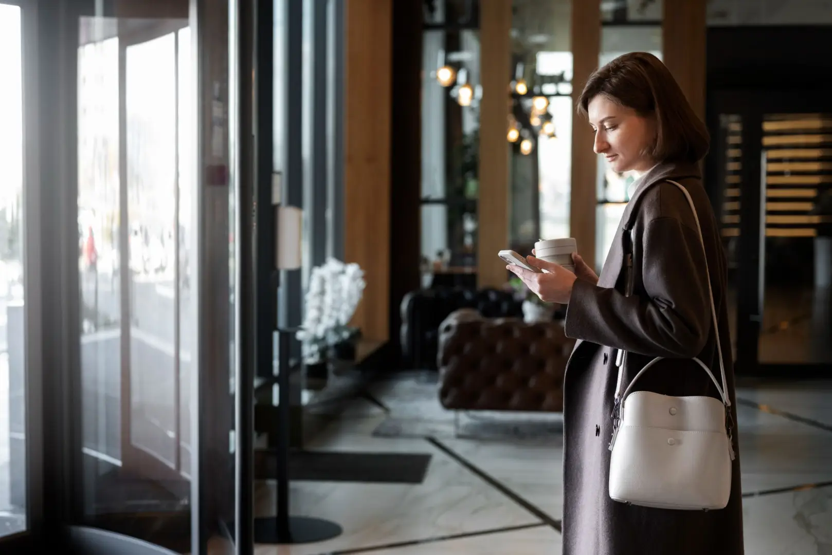 Is Self Check-In Actually Worth Installing? 1 Hotel guest using a smartphone for mobile hotel check-in before accessing room and hotel services